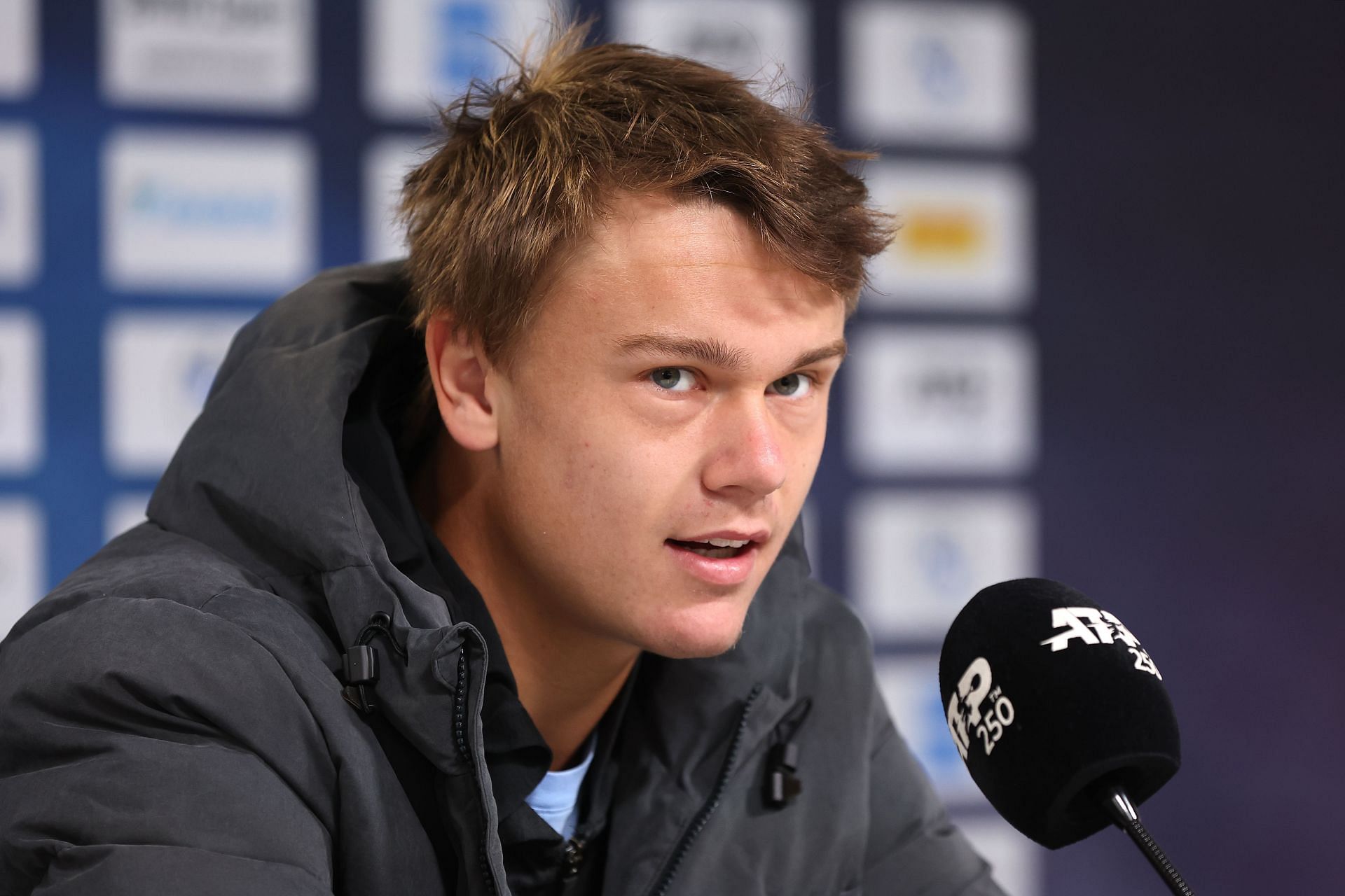 Holger Rune pictured speaking at a press conference [Image Source: Getty Images]