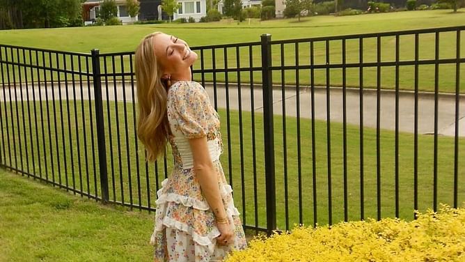 Erin Blaney shares a candid picture as she poses in a beautiful white dress