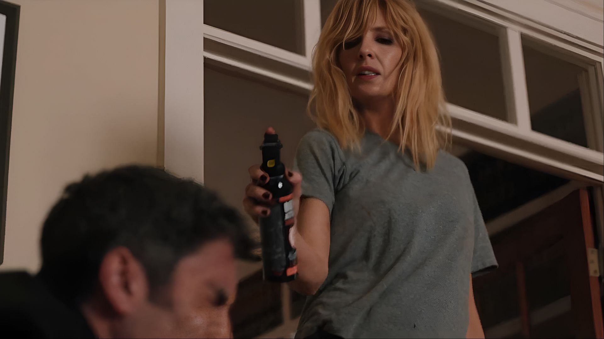 Armed and unrelenting, Beth uses bear spray on Jamie in one of the most talked-about moments from the Yellowstone finale. (Image via Paramount)