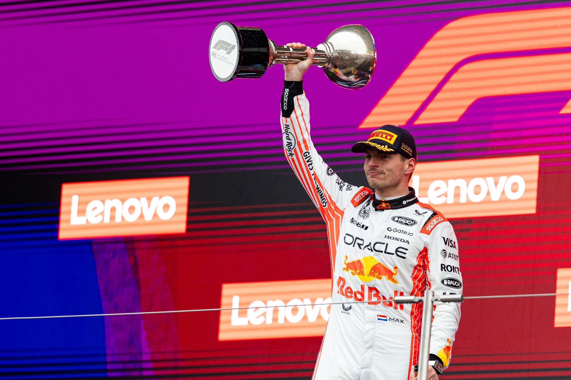 Max Verstappen raising his P1 trophy after the Japanese Grand Prix - Source: Getty