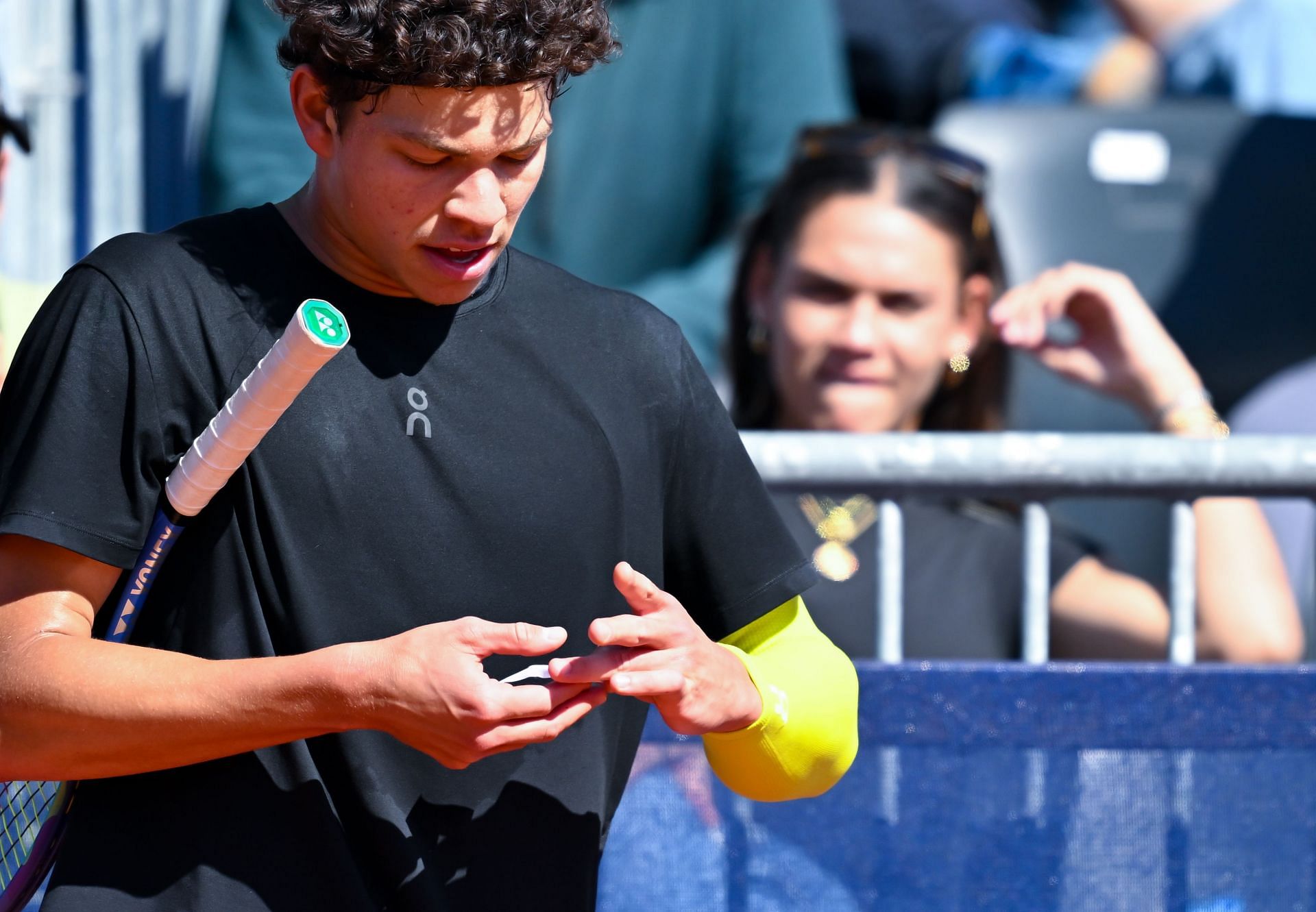 Ben Shelton pictured at the BMW Open with Trinity Rodman in the background | Image Source: Getty