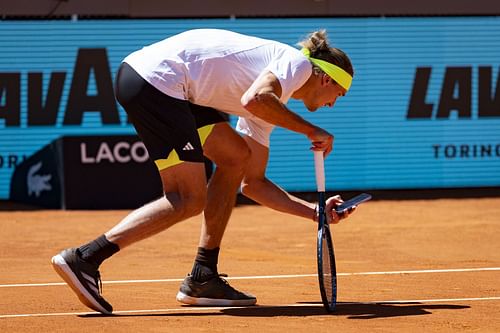Alexander Zverev takes a photo of a ball mark after a controversial line call during his third-round match against Alejandro Davidovich Fokina at the 2025 Madrid Open (Source: Getty)