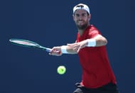 Karen Khachanov returns a shot against Nick Kyrgios during Day 4 of the Miami Open - Source: Getty