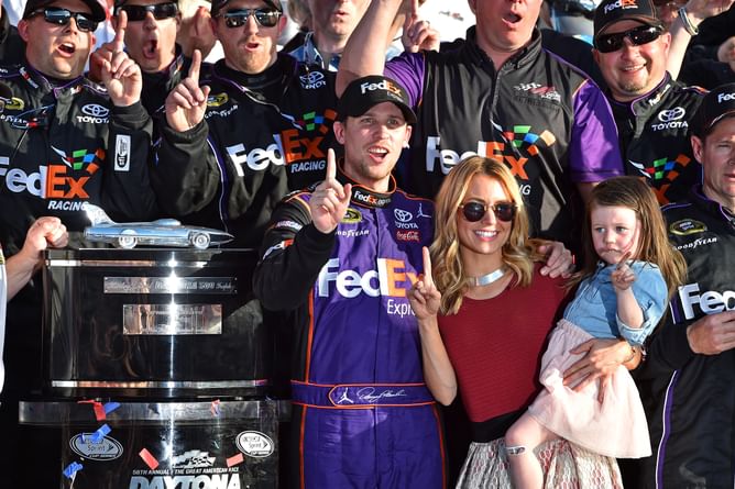 Jordan Fish stylishly flaunts her baby bump donning a printed red dress in photos celebrating beau Denny Hamlin's Martinsville triumph