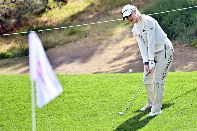 Charley Hull hits swing practice donned in red and white