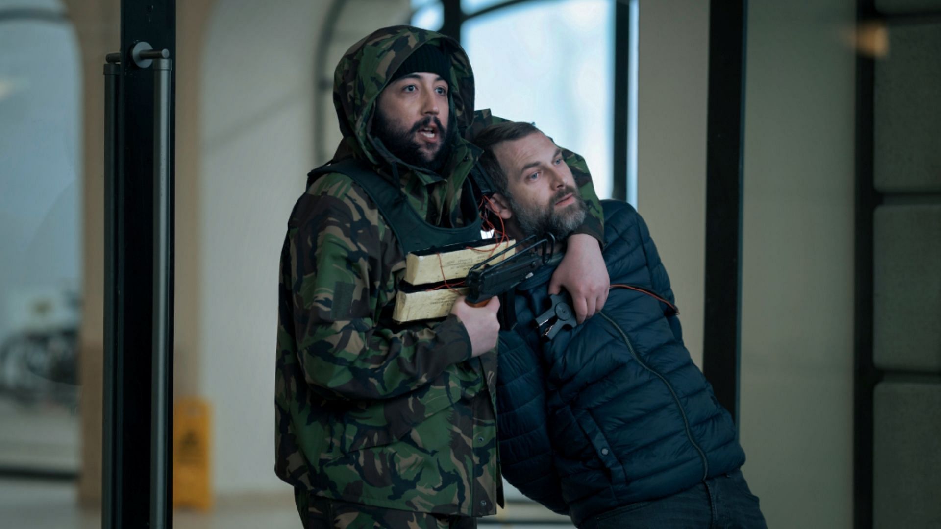 Ammar Ajar holding Ilian Petrov at gunpoint in iHostage (Image via Netflix)