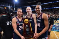 Kaitlyn Chen (#20), Paige Bueckers (#5) and Aubrey Griffin (#44) of the UConn Huskies pose for a photo with the trophy after defeating the South Carolina Gamecocks in the 2025 NCAA title game. Photo: Getty