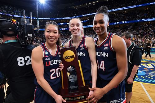 Kaitlyn Chen (#20), Paige Bueckers (#5) and Aubrey Griffin (#44) of the UConn Huskies pose for a photo with the trophy after defeating the South Carolina Gamecocks in the 2025 NCAA title game. Photo: Getty