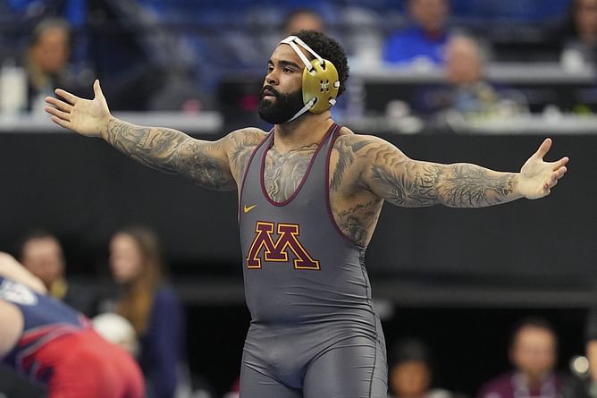 Gable Steveson hilariously reacts after showing off gymnastics skills with front flips on the mat