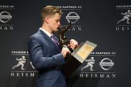 Heisman Trophy winner Joe Burrow kisses the trophy - Source: Imagn