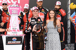 Christopher Bell participates in Arlington's wreath-laying ceremony alongside his wife and JGR president