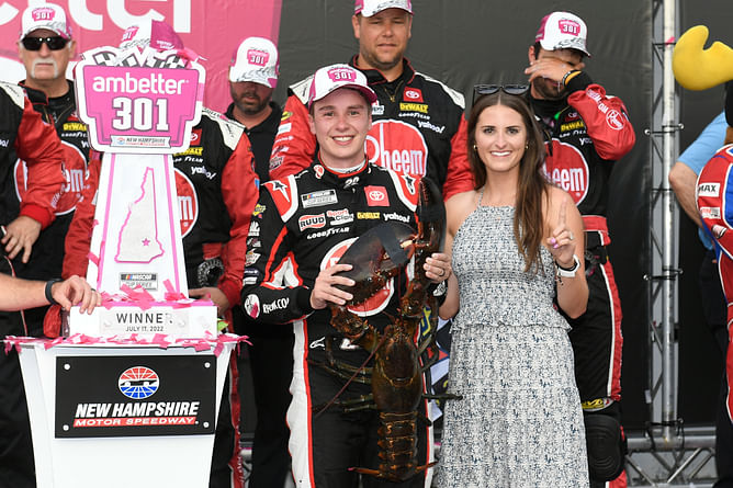 Christopher Bell participates in Arlington's wreath-laying ceremony alongside his wife and JGR president