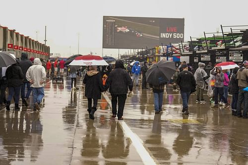 Fans walk in the garage area before the Coca-Cola 600 at Charlotte Motor Speedway. Source: Imagn