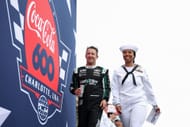 A.J. Allmendinger with a military service member during the 2025 Coca-Cola 600 - Source: Getty