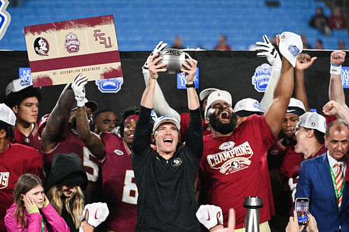 lorida State Seminoles head coach Mike Norvell raises the ACC Championship trophy - Source: Imagn