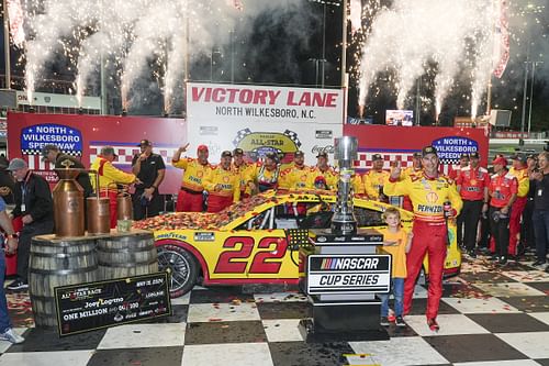 Joey Logano (22) celebrates his win with his team during the All-Star Race at North Wilkesboro Speedway. - Source: Imagn