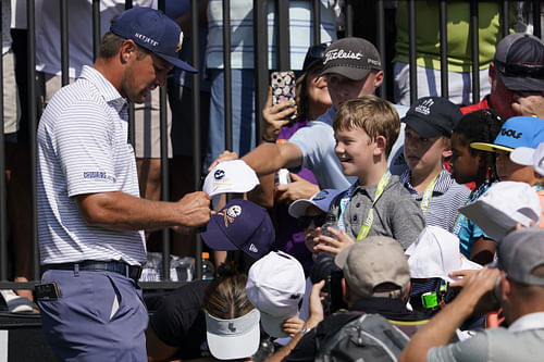 DeChambeau signing autographs during Golf: LIV Golf Dallas Team Championship Semifinals - Source: Imagn