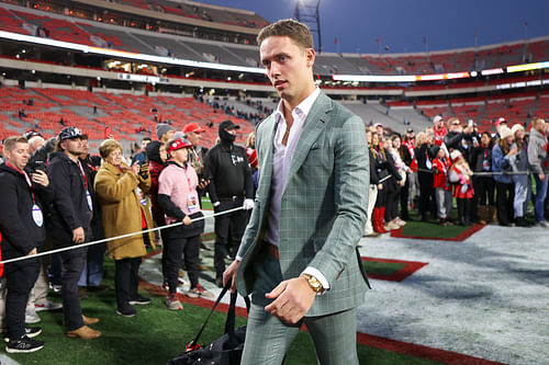 QB Beck (15) walks into Sanford Stadium - Source: Imagn