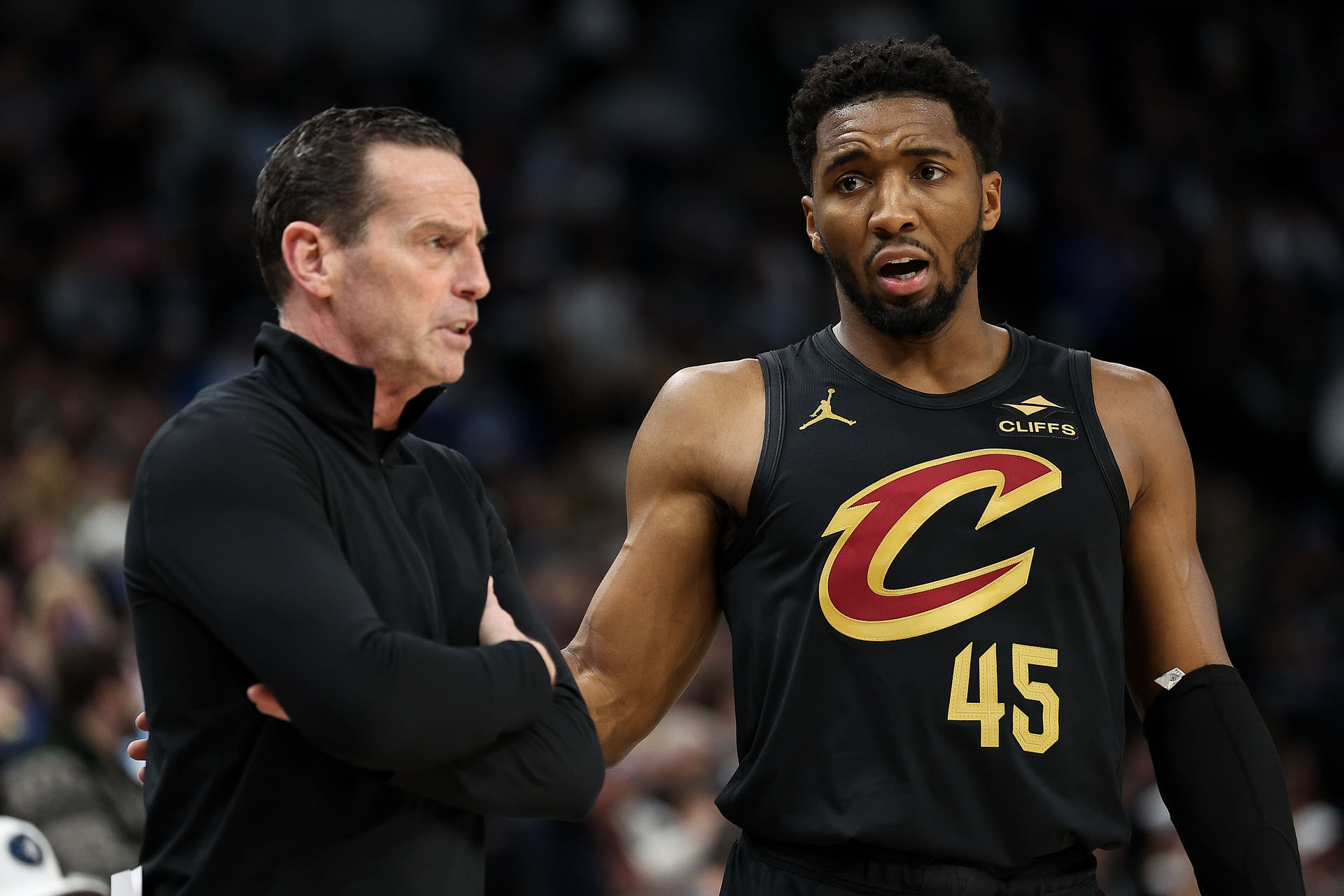 Jan 18, 2025; Minneapolis, Minnesota, USA; Cleveland Cavaliers guard Donovan Mitchell (45) talks with head coach Kenny Atkinson during the second quarter against the Minnesota Timberwolves at Target Center. Mandatory Credit: Matt Krohn-Imagn Images - Source: Imagn