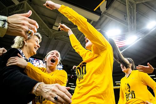 Lisa Bluder gets embraced by Kate Martin, second from left, and Caitlin Clark - Source: Imagn