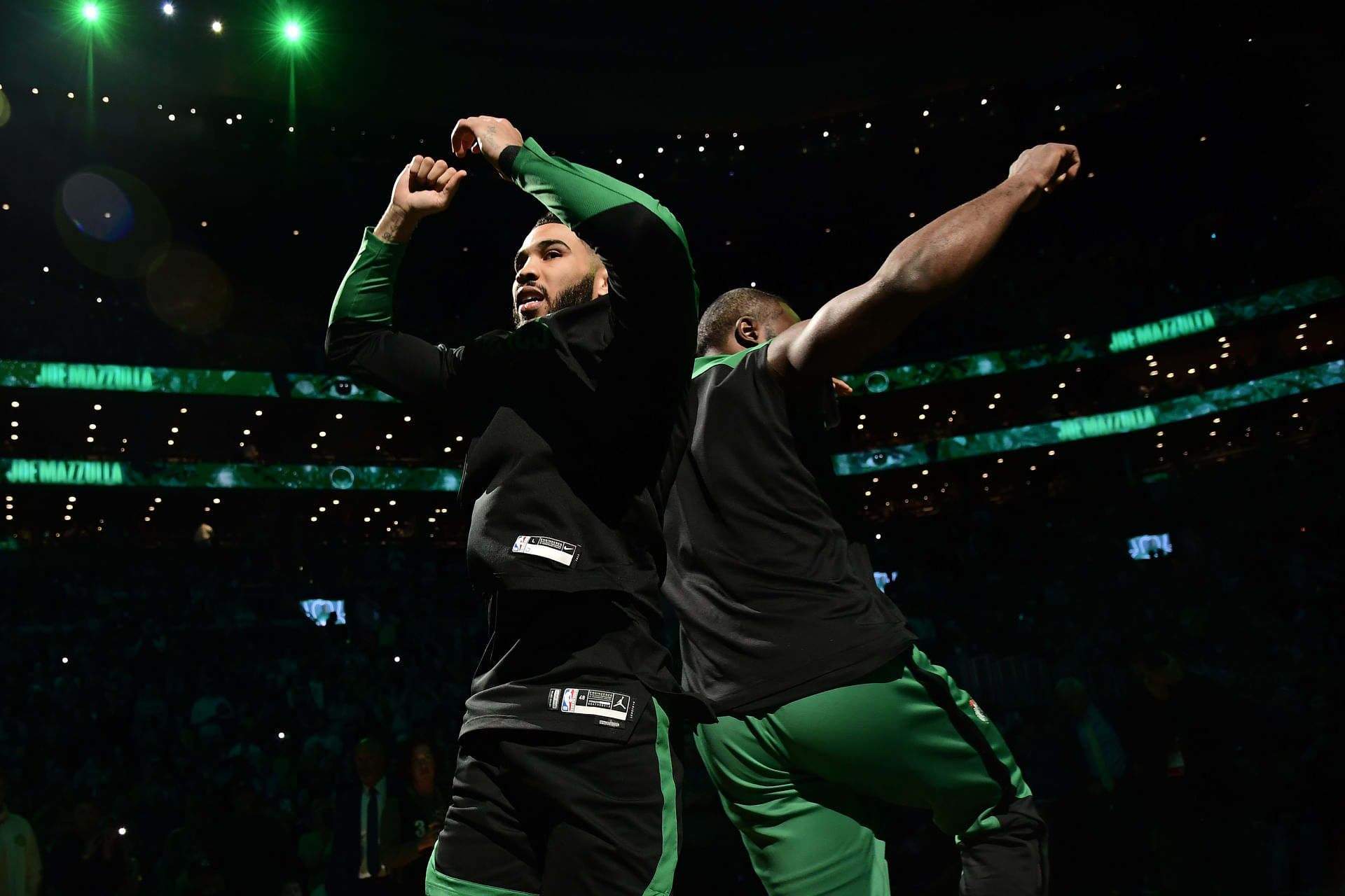 Apr 2, 2025; Boston, Massachusetts, USA; Boston Celtics forward Jayson Tatum (0) and forward Torrey Craig (12) react prior to a game against the Miami Heat at TD Garden. Mandatory Credit: Bob DeChiara-Imagn Images - Source: Imagn