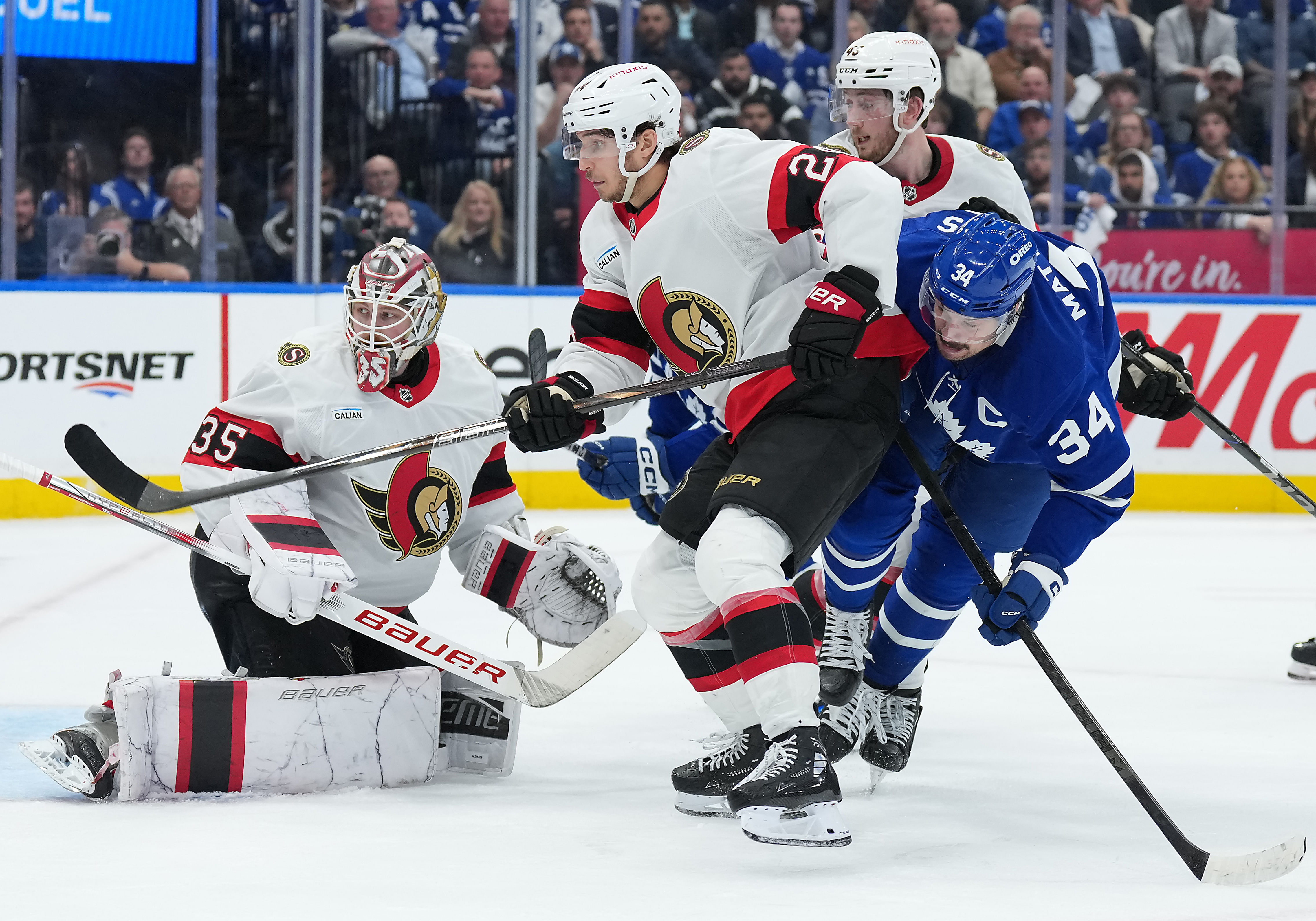 Apr 29, 2025; Toronto, Ontario, CAN; Toronto Maple Leafs center Auston Matthews (34) battles with Ottawa Senators center Dylan Cozens (24) in the third period during game five of the first round of the 2025 Stanley Cup Playoffs at Scotiabank Arena. Mandatory Credit: Nick Turchiaro-Imagn Images - Source: Imagn