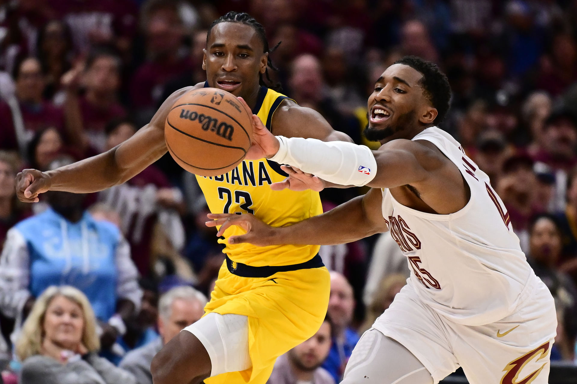 May 4, 2025; Cleveland, Ohio, USA; Cleveland Cavaliers guard Donovan Mitchell (45) goes for a loose ball against Indiana Pacers forward Aaron Nesmith (23) during the second half in game one of the second round for the 2025 NBA Playoffs at Rocket Arena. Mandatory Credit: Ken Blaze-Imagn Images - Source: Imagn