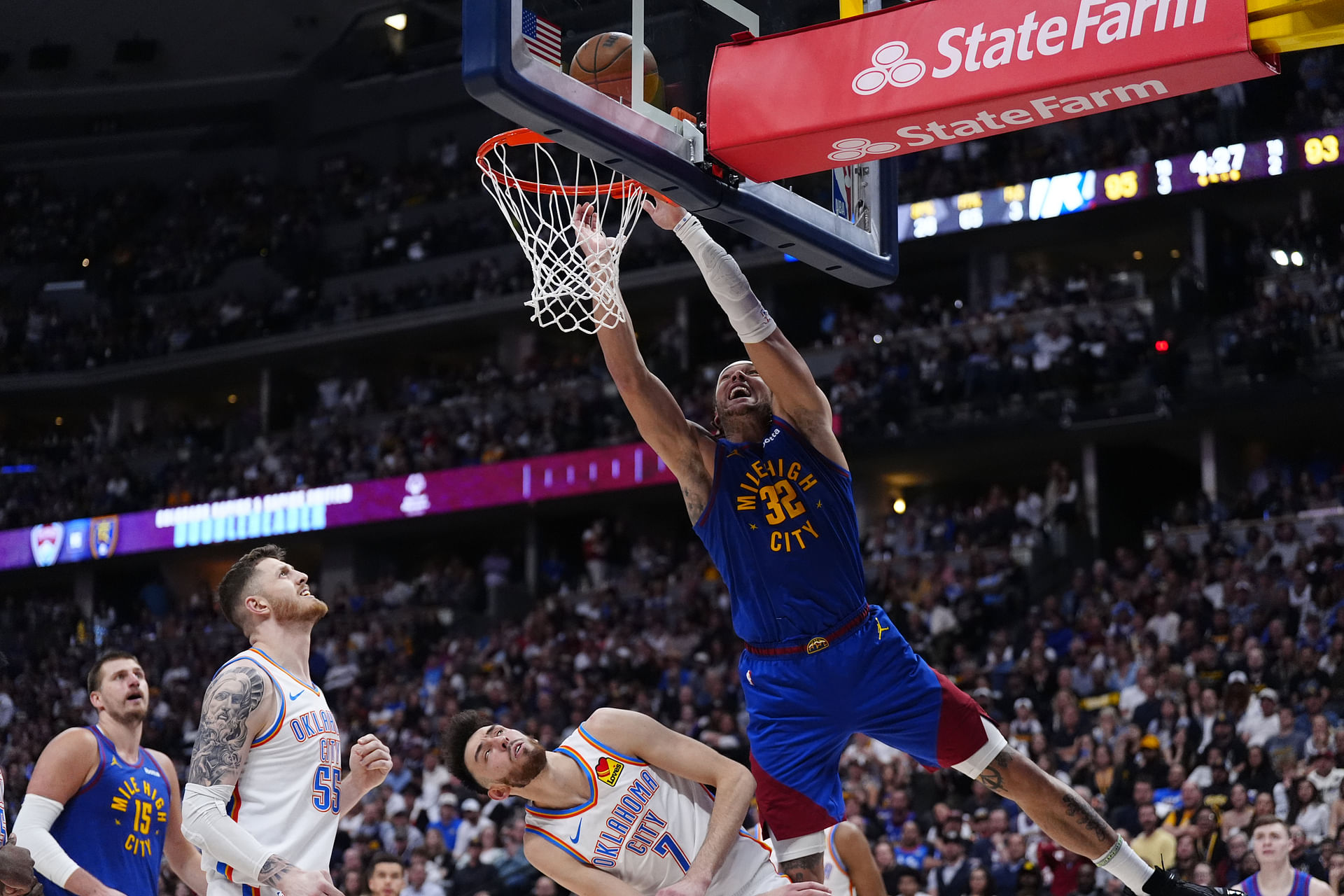 May 9, 2025; Denver, Colorado, USA; Oklahoma City Thunder center Isaiah Hartenstein (55) and forward Chet Holmgren (7) defend on Denver Nuggets forward Aaron Gordon (32) in the second half during game three of the second round for the 2025 NBA Playoffs at Ball Arena. Mandatory Credit: Ron Chenoy-Imagn Images - Source: Imagn