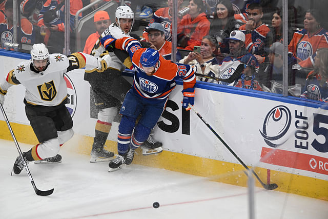 May 10, 2025; Edmonton, Alberta, CAN; Las Vegas Golden Knights defenceman Nicolas Hague (14) and Knights defenceman Zach Whitecloud (2) battle for the puck during the third period in game three of the second round of the 2025 Stanley Cup Playoffs at Rogers Place. Mandatory Credit: Walter Tychnowicz-Imagn Images - Source: Imagn