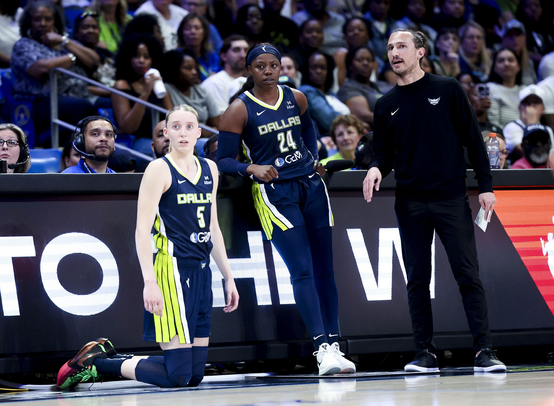 May 16, 2025; Arlington, Texas, USA; Dallas Wings guard Paige Bueckers (5) and Dallas Wings guard Arike Ogunbowale (24) and Dallas Wings head coach Chris Koclanes talk against the Minnesota Lynx during the first half at College Park Center. Mandatory Credit: Kevin Jairaj-Imagn Images - Source: Imagn