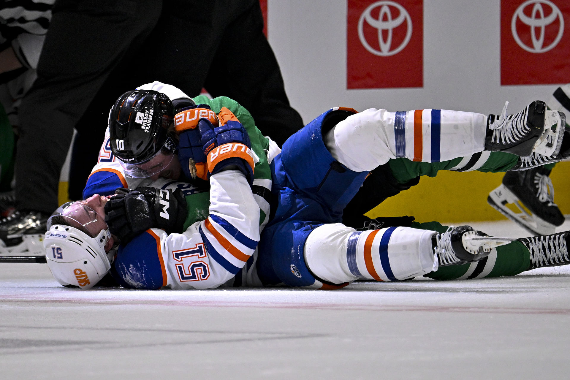 May 21, 2025; Dallas, Texas, USA; Edmonton Oilers defenseman Troy Stecher (51) fights with Dallas Stars center Oskar Back (10) at the end of the game between the Stars and the Oilers in game one of the Western Conference Final of the 2025 Stanley Cup Playoffs at American Airlines Center. Mandatory Credit: Jerome Miron-Imagn Images - Source: Imagn