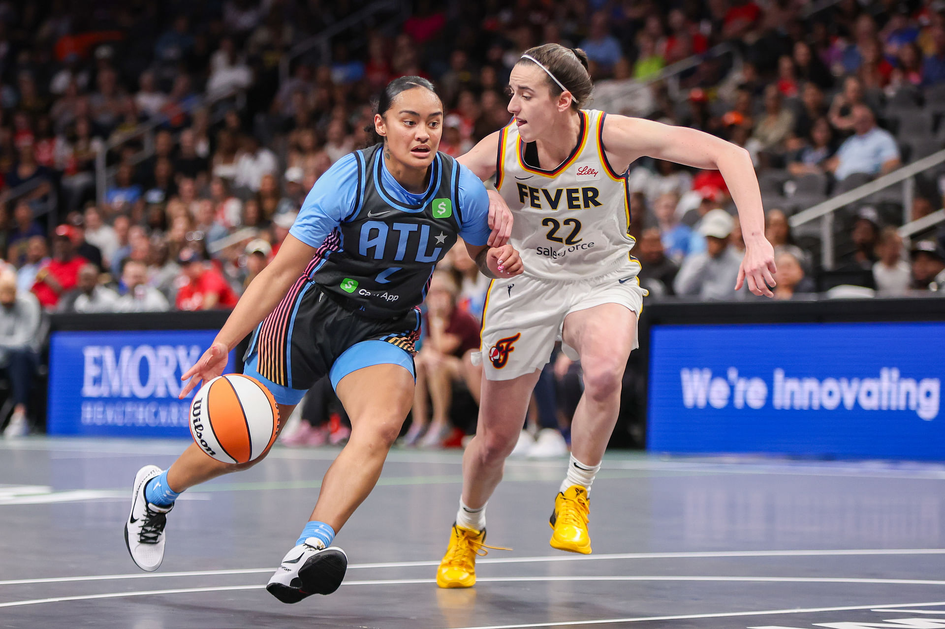 May 22, 2025; Atlanta, Georgia, USA; Atlanta Dream guard Te-Hina Paopao (2) drives on Indiana Fever guard Caitlin Clark (22) in the first half at State Farm Arena. Mandatory Credit: Brett Davis-Imagn Images - Source: Imagn