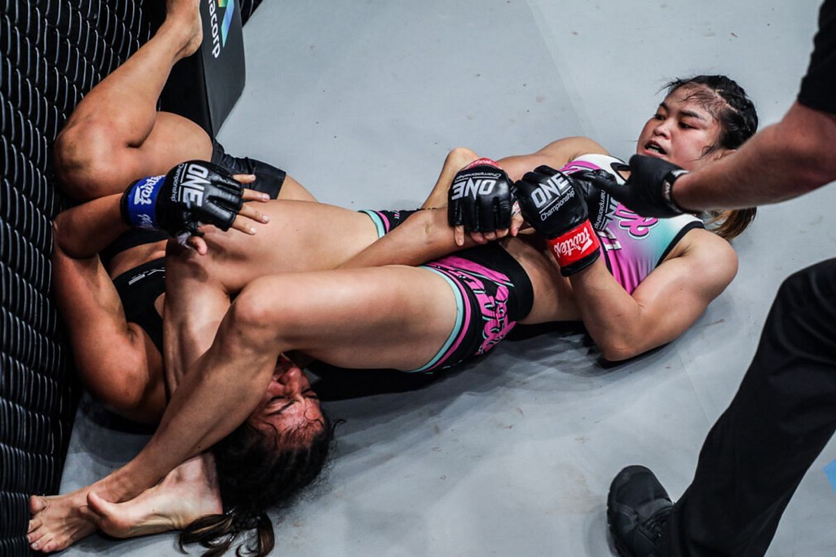 Stamp executes an armbar submission on wrestling ace Ritu Phogat. -- Photo by ONE Championship