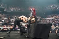 Rhea Ripley brutally powerbombs Iyo Sky through a table... and Bianca Belair - Source: Getty