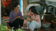 Mỹ Tiên and her mother share a quiet moment of care and connection, reflecting the film’s central theme of generational healing. (Image via Skyline Media)