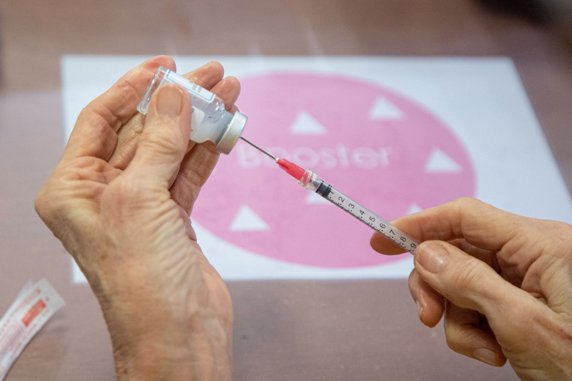 Healthcare Workers Prepare The Moderna Booster Vaccine For COVID-19 - Source: Getty
