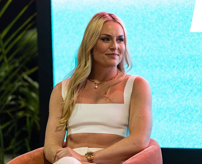 Lindsey Vonn sports Gucci bag in all white business casual outfit