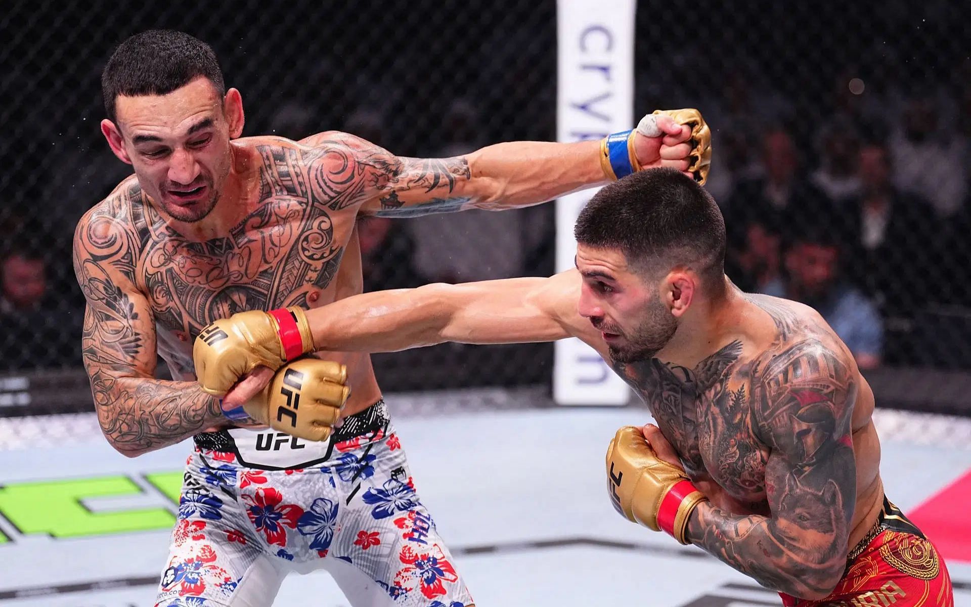 Max Holloway (right) sends hilarious message to an Ilia Topuria (left) supporter at a seminar. [Images courtesy: Getty Images]