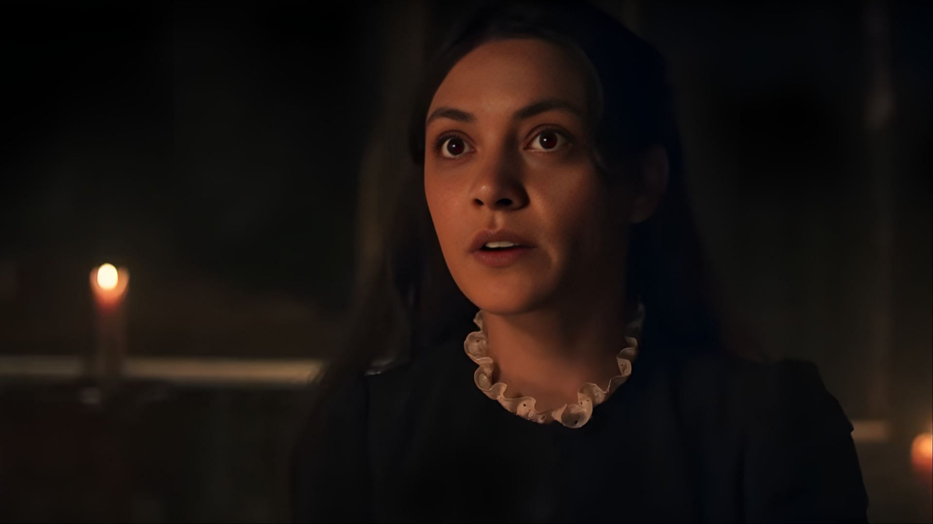 Amelia Rojas appears tense during a dimly lit scene in Sherlock & Daughter episode 2, following critical discoveries about Clara Anderson’s disappearance. (Image via CW)