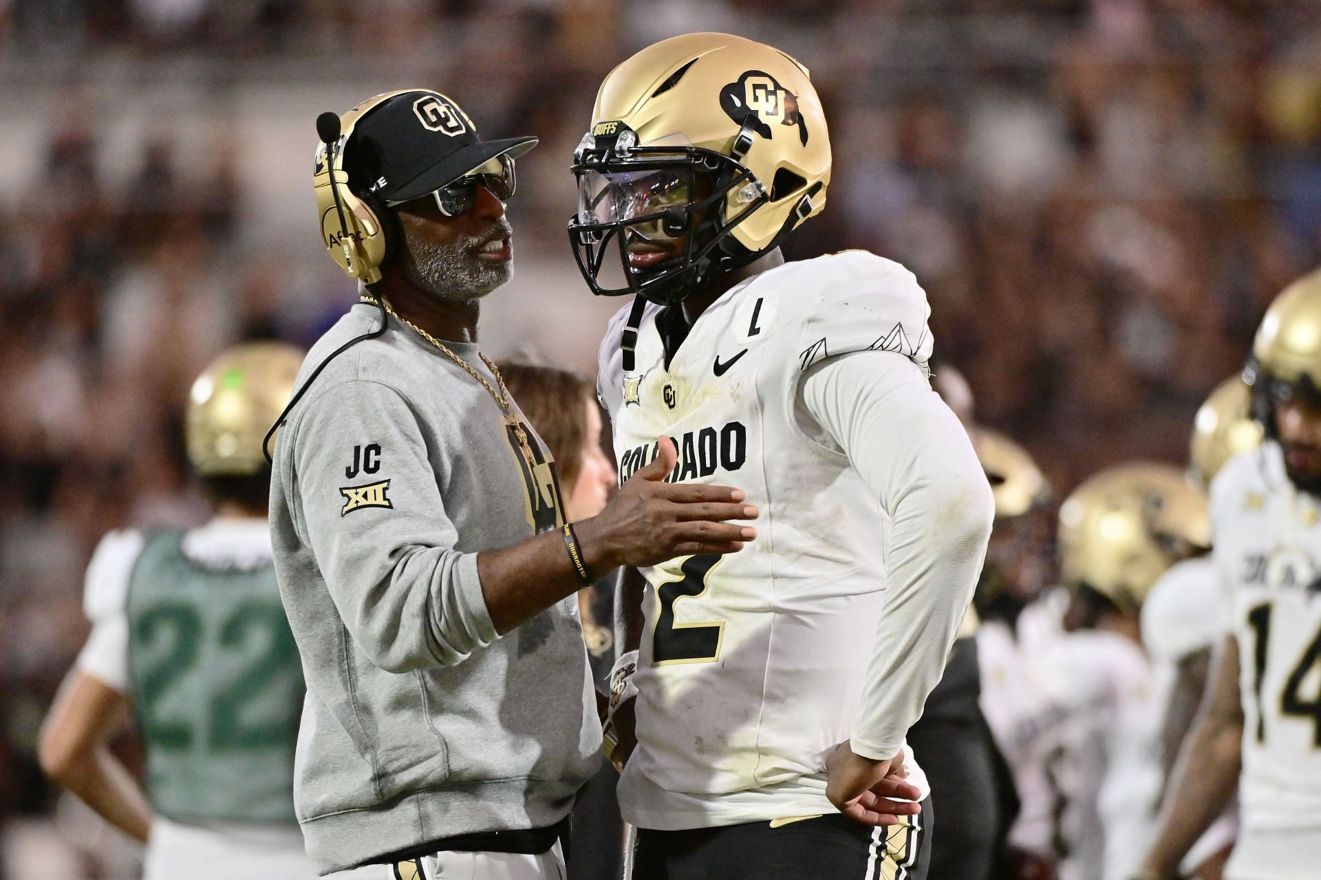 ORLANDO, FLORIDA - SEPTEMBER 28: Head coach Deion Sanders of the Colorado Buffaloes talks with Shedeur Sanders #2 during the second half of a game against the UCF Knights at FBC Mortgage Stadium on September 28, 2024 in Orlando, Florida. (Photo by Julio Aguilar/Getty Images) - Source: Getty