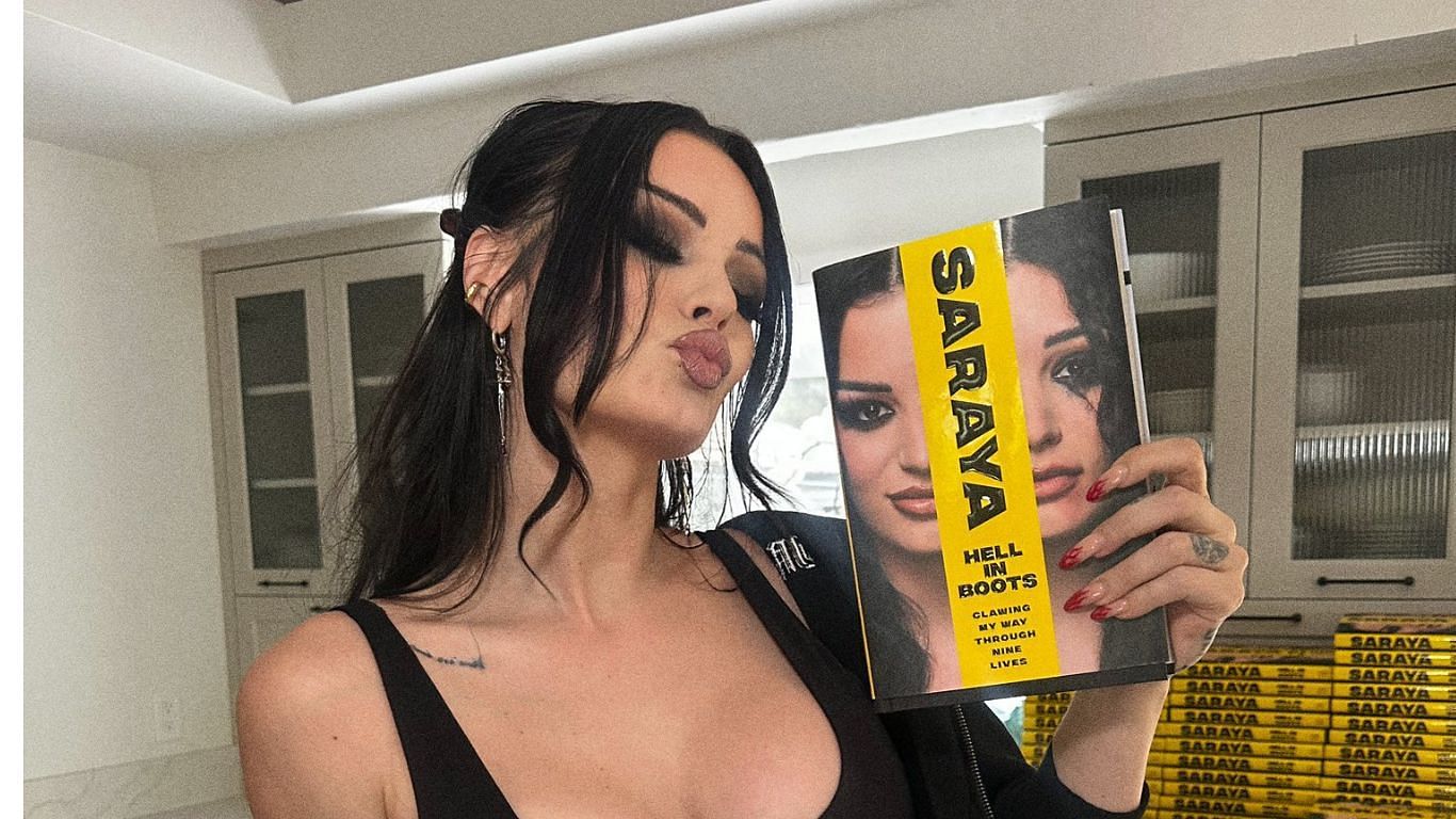 Saraya posing with her book [ image from Saraya