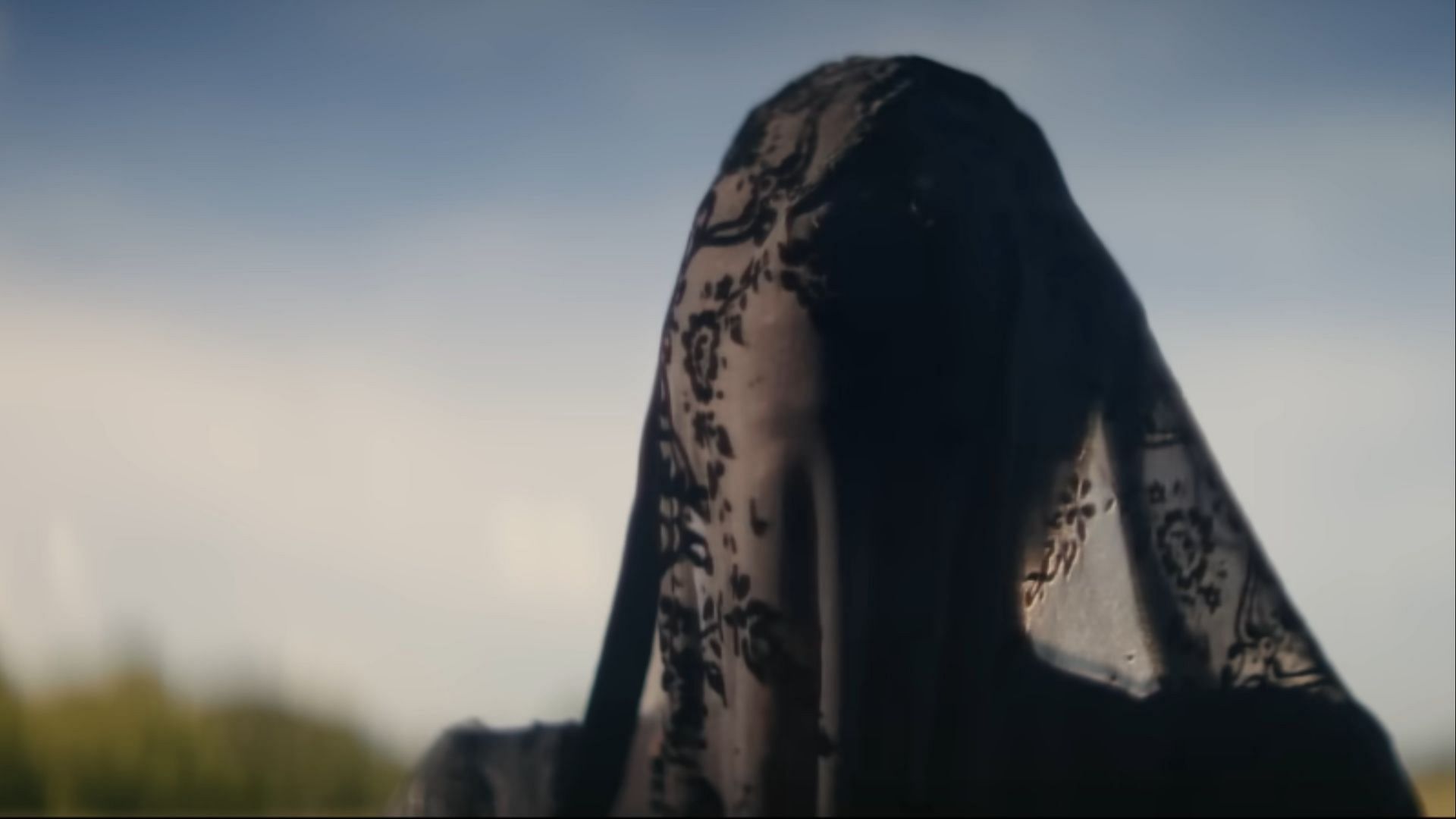 In The Woman in the Yard, her lace veil clings tightly to her face, as if grief itself had taken human form. (Image via Universal)