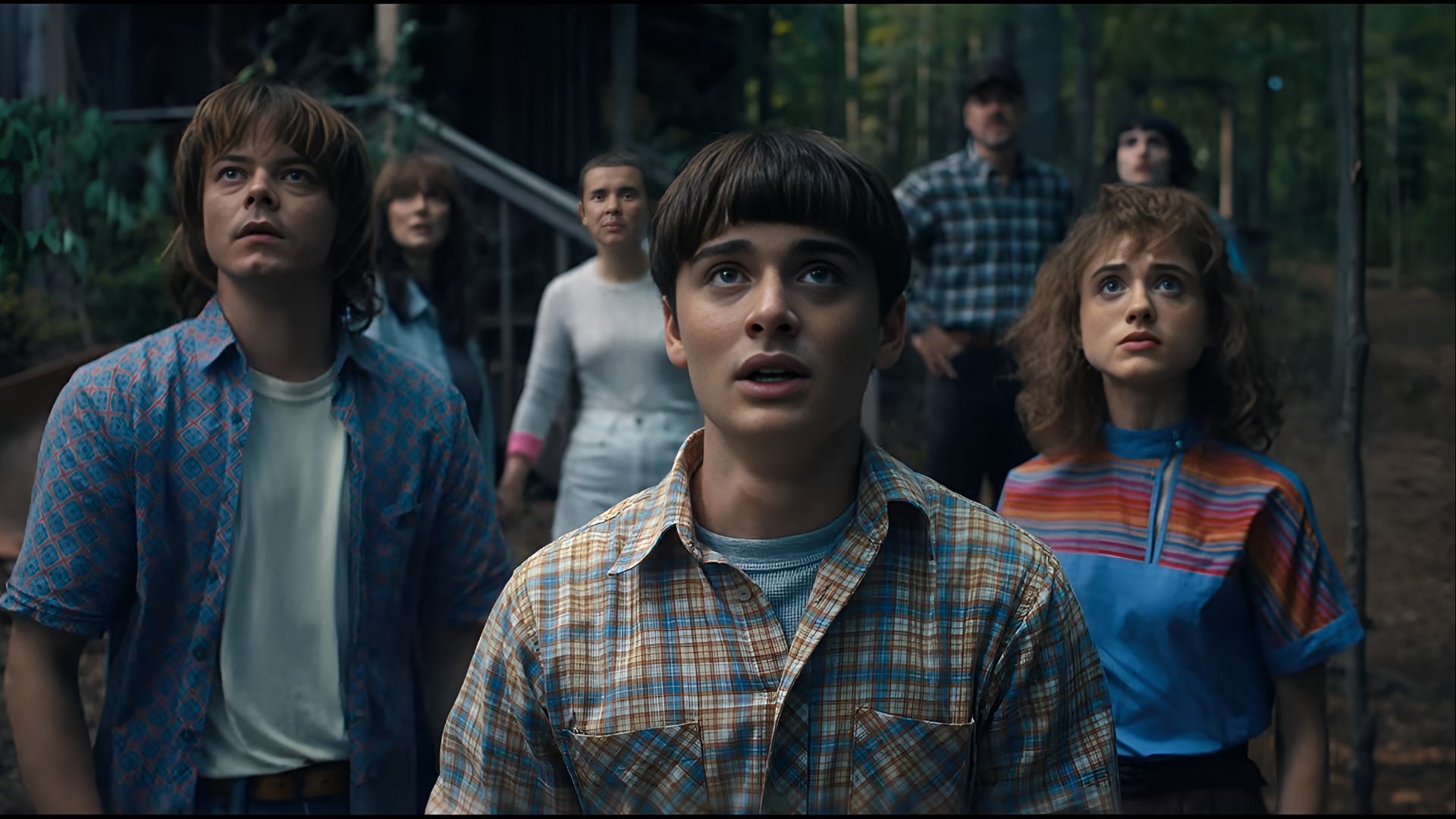 The core cast of Stranger Things watches in fear as their world begins to collapse, unaware of the dark turn Eleven is about to take. (Image via Netflix)