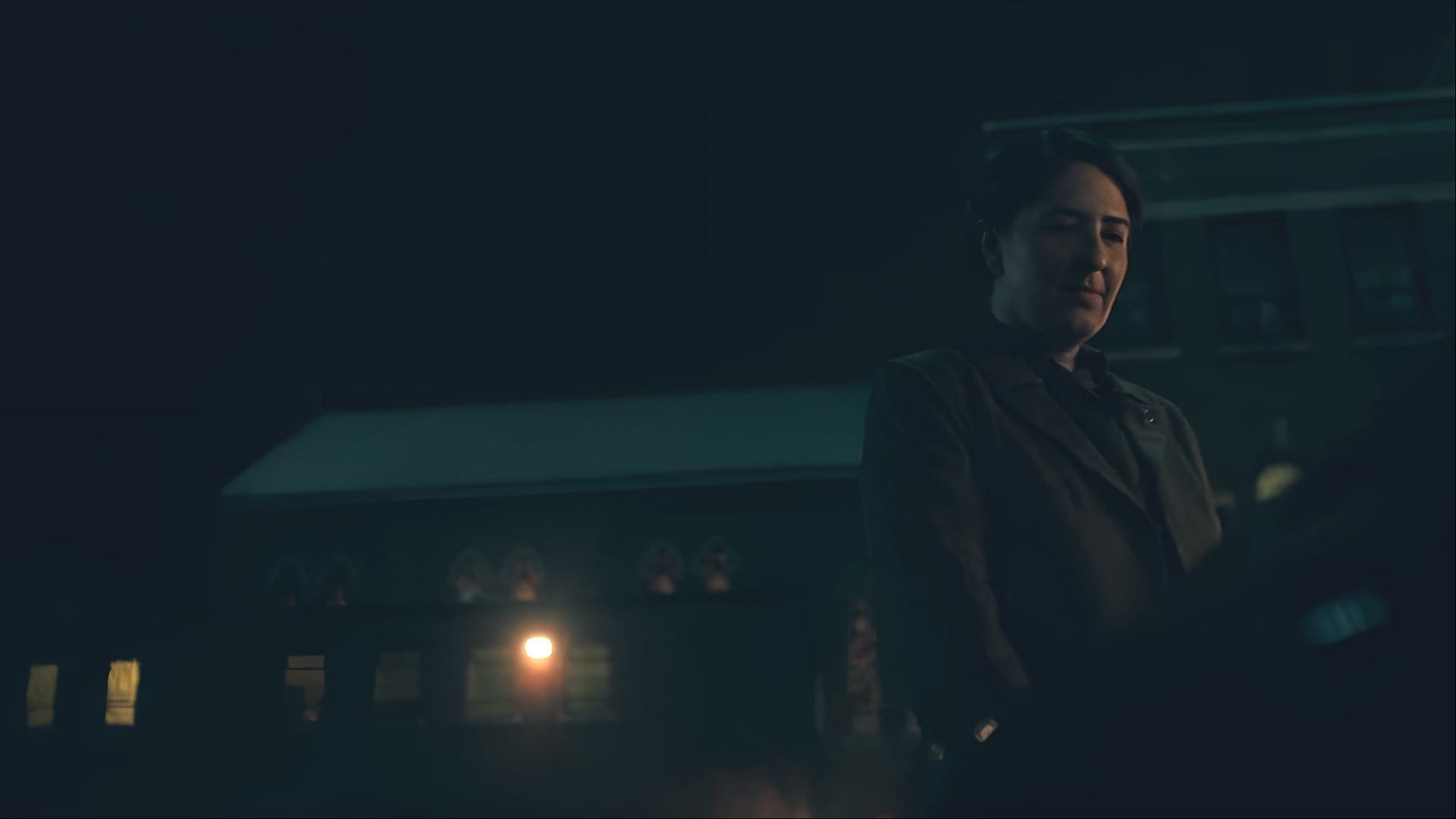 Under the cold night sky, Aunt Phoebe stands watchful and alone, a silent force within The Handmaid's Tale’s growing rebellion. (Image via Hulu)