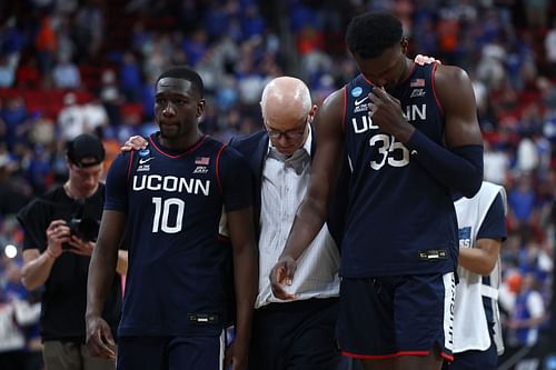 Head coach Dan Hurley of the UConn Huskies walks off the court with Hassan Diarra (#10) and Samson Johnson (#35) after losing to the Florida Gators 77-75 in the second round of the 2025 NCAA Men's Basketball Tournament at Lenovo Center. Photo: Getty