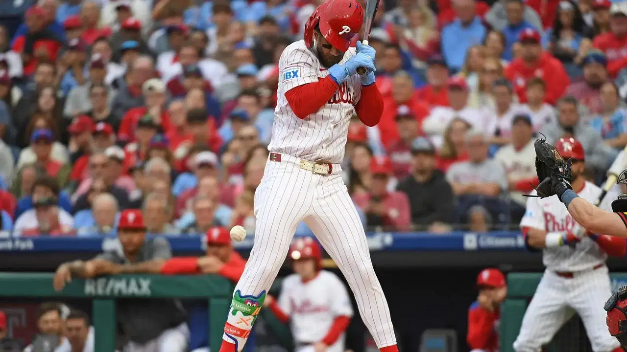 Bryce Harper reacts after getting hit (Imagn)