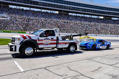 Denny Hamlin (#11) is towed into the pits after blowing an engine during the NASCAR Cup Series Wurth 400  - Source: Getty