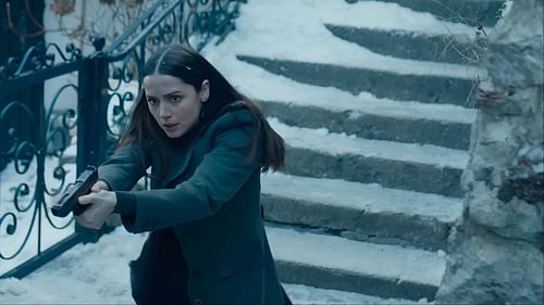 Eve storms the icy steps of Hallstatt with fierce determination, ready to confront her enemies head-on. (Image via Lionsgate movies)