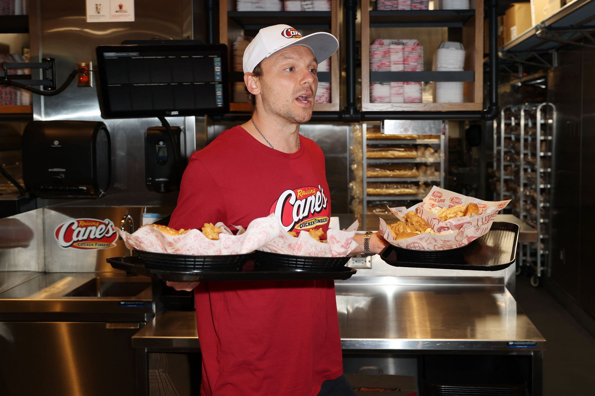 Sam Reinhart serving some chicken (Image via Raising Cane