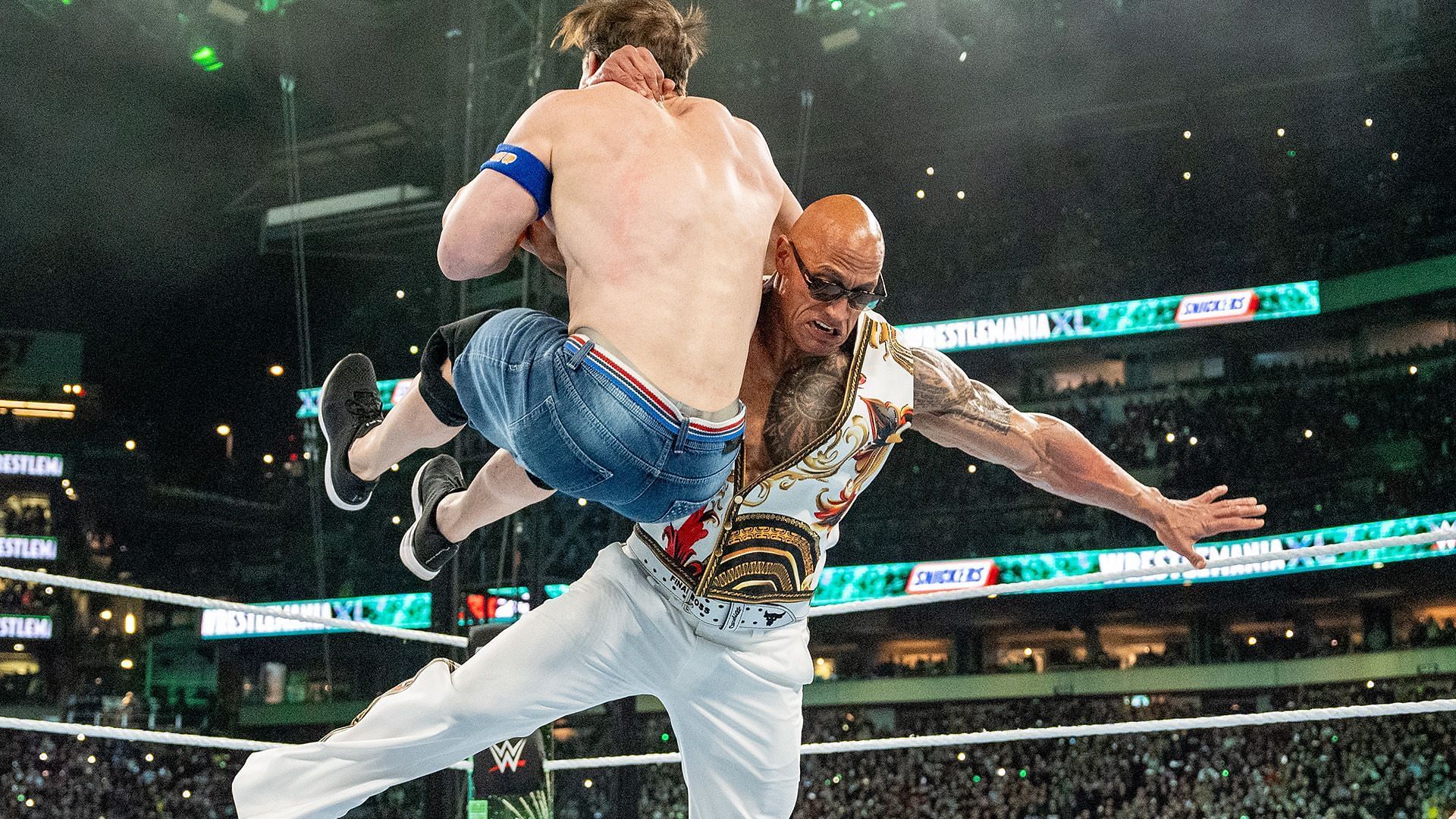 The Rock attacks John Cena (Image via WWE.com)